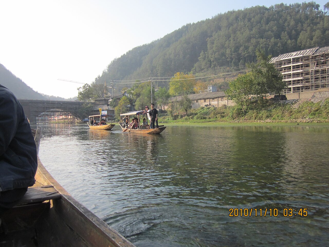 Green river with old buildings on both banks
