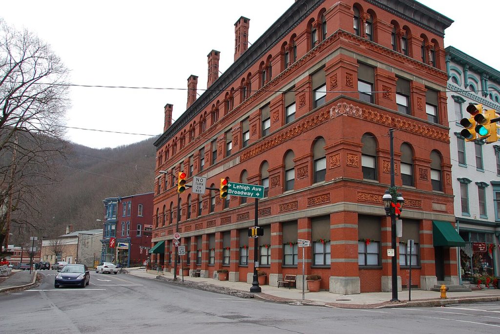 Victorian brick buildings along a sloping main street