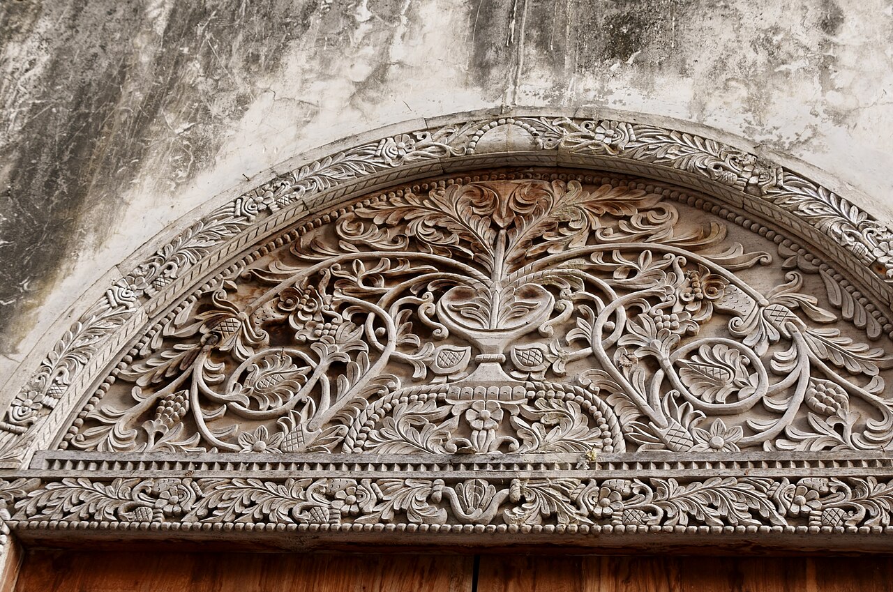 Carved wooden door with brass studs