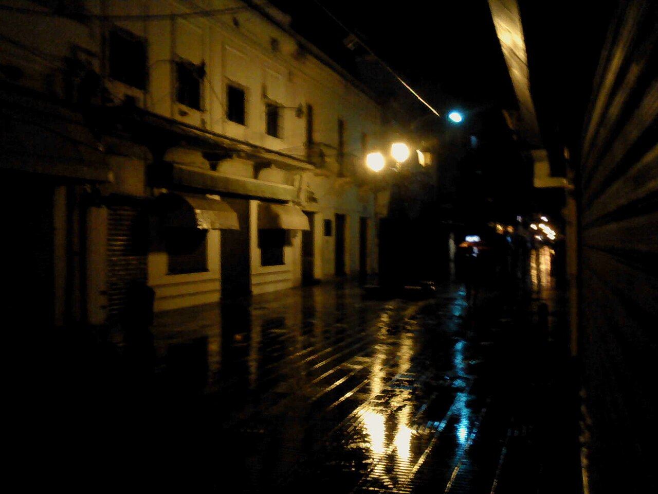 Colonial street with lights and restaurants at night