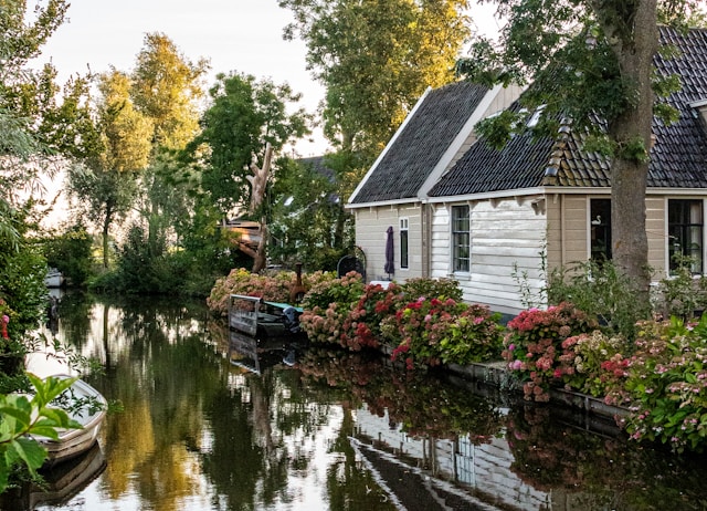 Canal house with flowers in Broek in Waterland, Netherlands